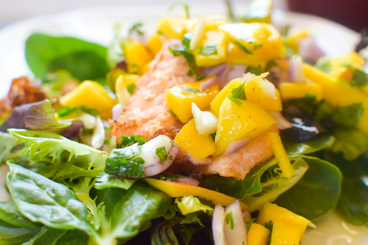 close up photo of roasted salmon with mango salsa