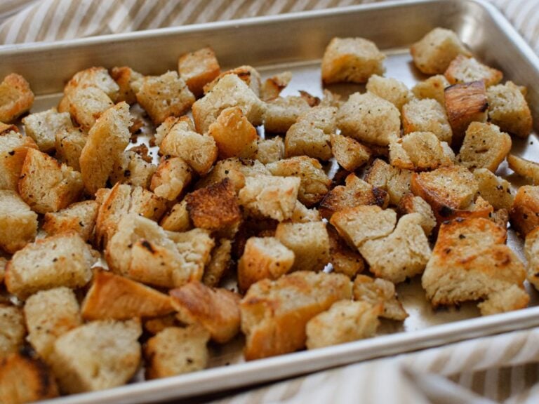 homemade sourdough croutons on a baking sheet